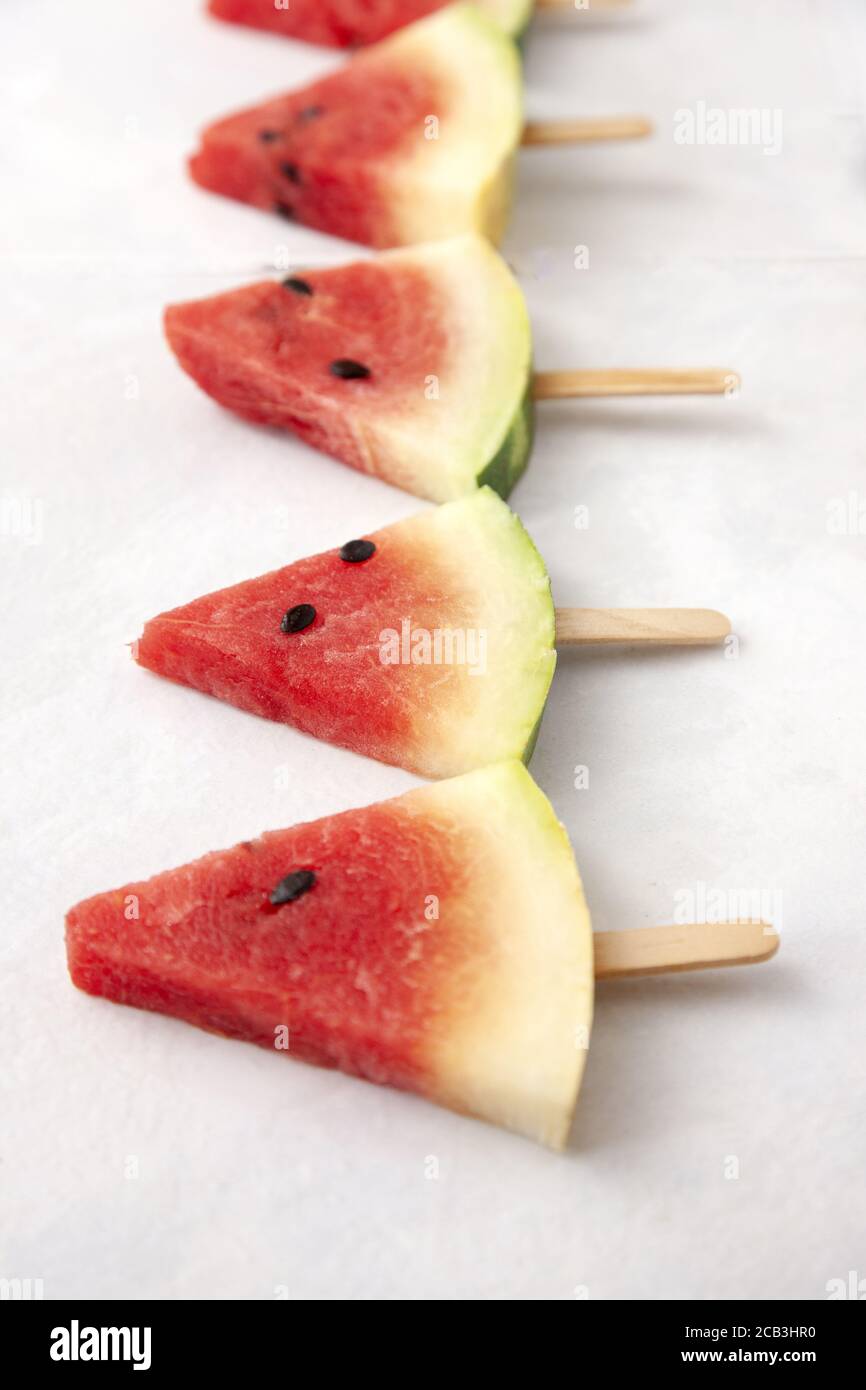 Top view of triangular cut popsicle watermelons on a white background ...