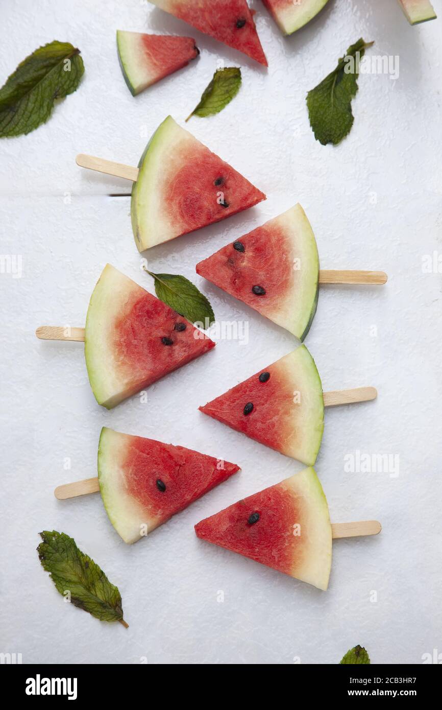 Top view of triangular cut popsicle watermelons on a white background ...
