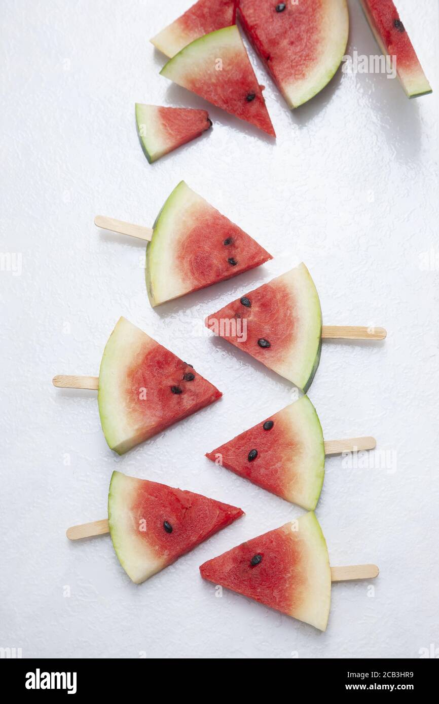 Top view of triangular cut popsicle watermelons on a white background ...