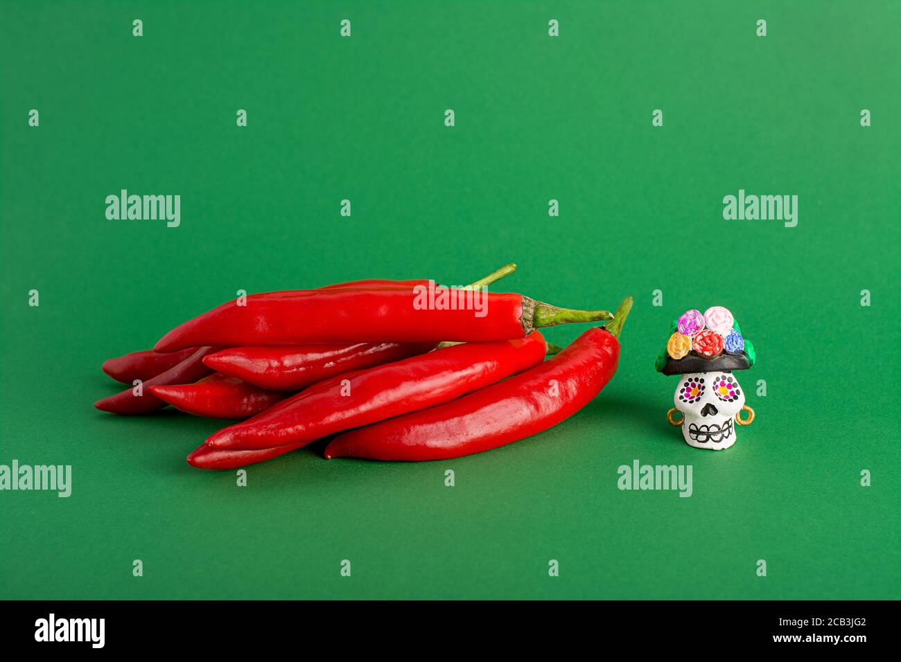 Red hot chili pepper and Catrina La Calavera Garbancera , Dapper Skeleton, Elegant Skull Stock Photo