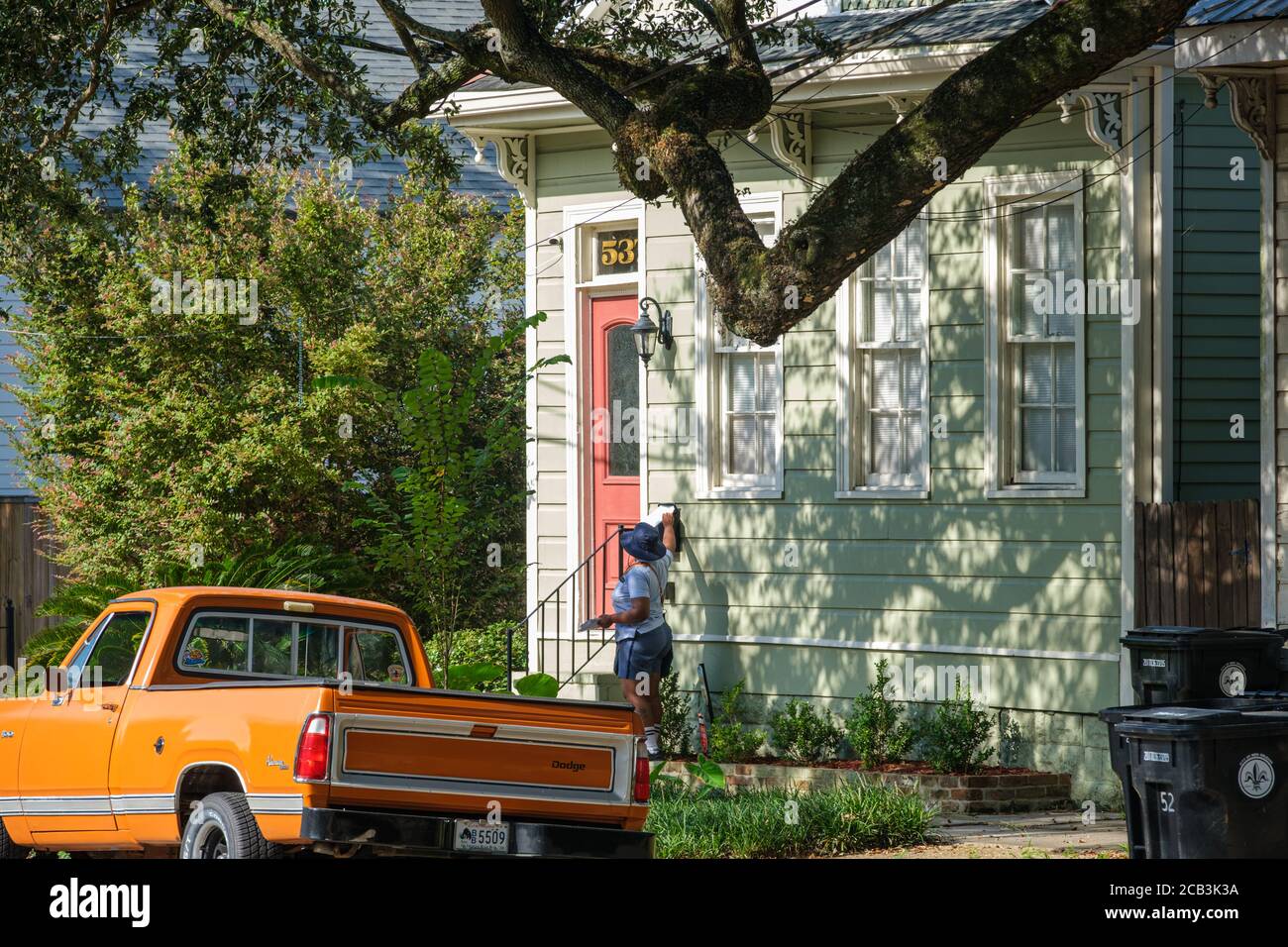 New Orleans, Louisiana/USA - 8/8/2020: Mail Carrier Delivering Mail in Uptown Neighborhood Stock Photo