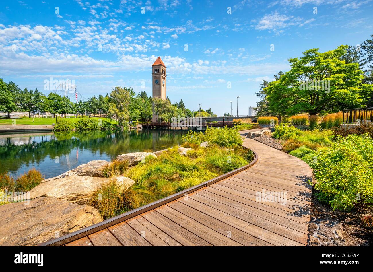Summer day along the Spokane River in Riverfront Park with the Clock Tower, Pavilion and walking path in view. Stock Photo