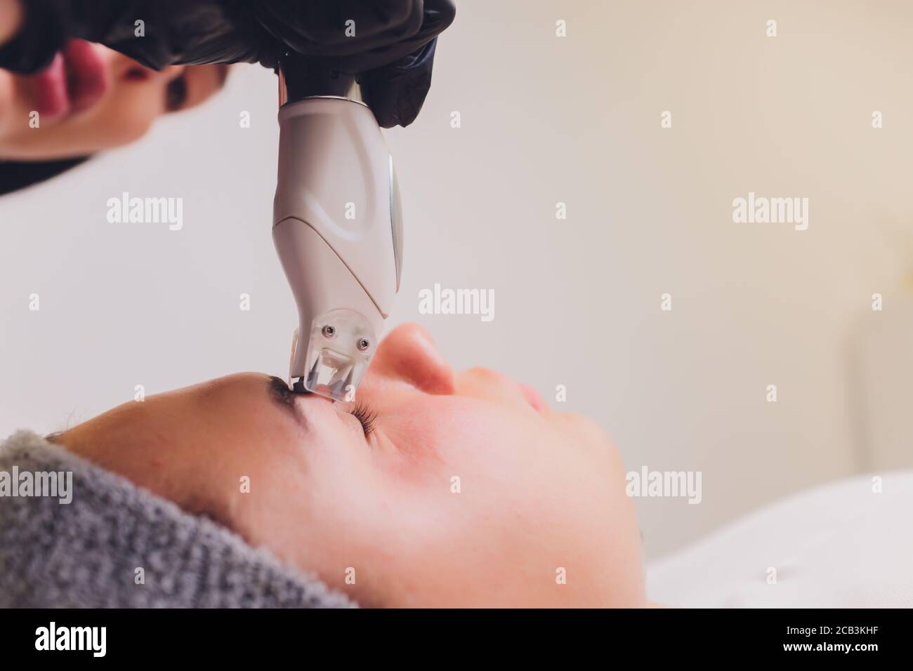 Lymphatic drainage massage LPG apparatus process. Therapist beautician makes a rejuvenating facial massage for the model in a beauty salon. Close up Stock Photo