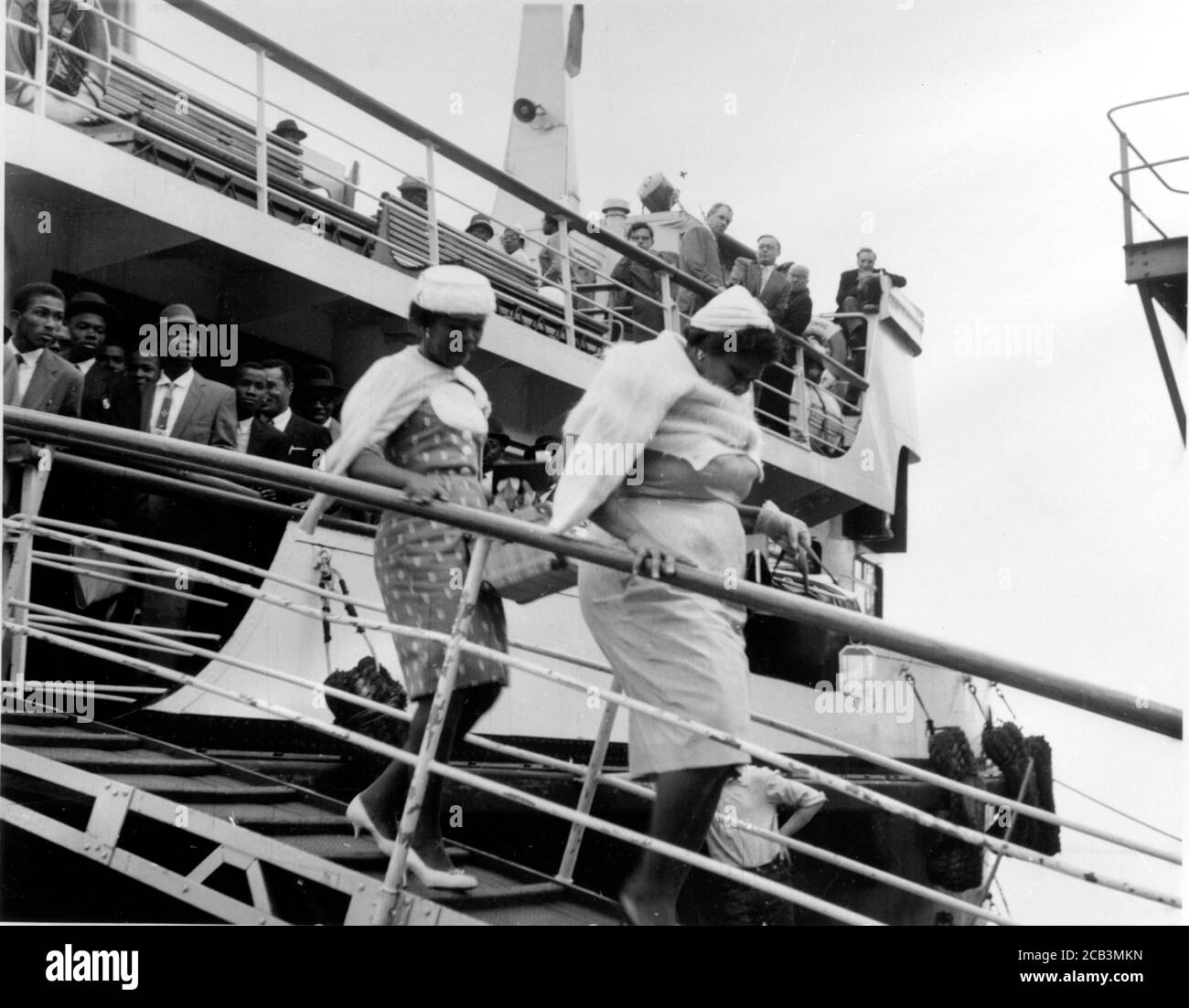 Men, women and children from the Caribbean arrive at Southampton in 1962 at the invitation of the British Government to help with rebuilding Britain after World War II. These people became the Windrush Generation due to their treatment by the British Home Office under a hostile environment policy where employers and other organisations were required to ask for visas. Stock Photo