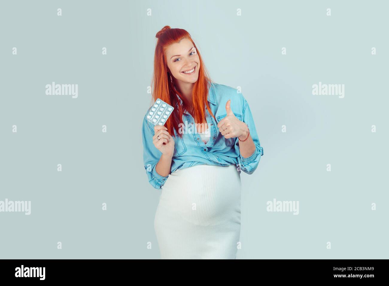 Vitamins and minerals is good during pregnancy. Charming young woman