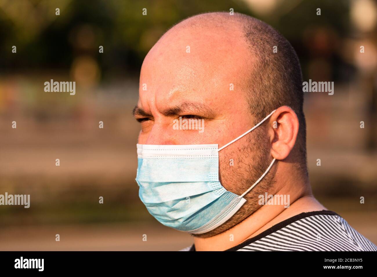 Young man with medical protective face mask illustrates pandemic ...