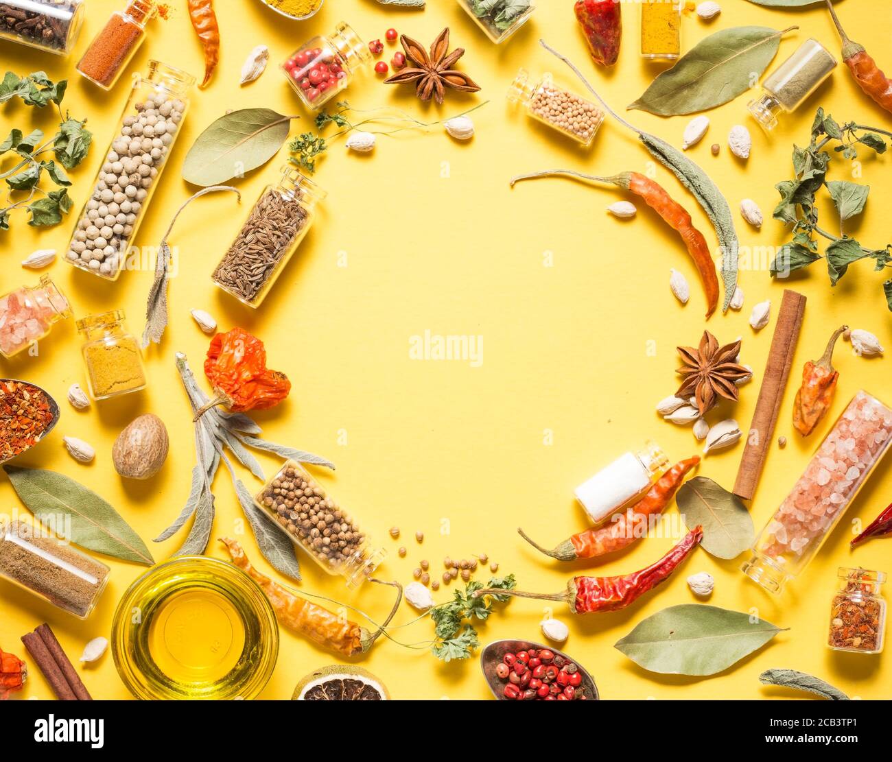 Various herbs and spices on yellow background Stock Photo Alamy