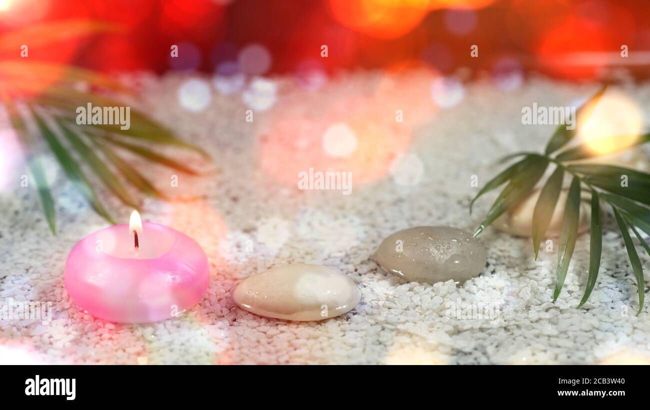 Zen garden with a burning candle Stock Photo