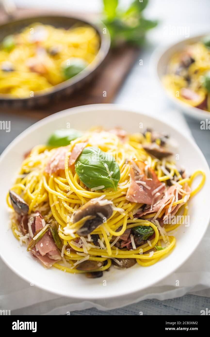 Italian pasta spaghetti prosciutto mushrooms parmesan and olive oil Stock Photo