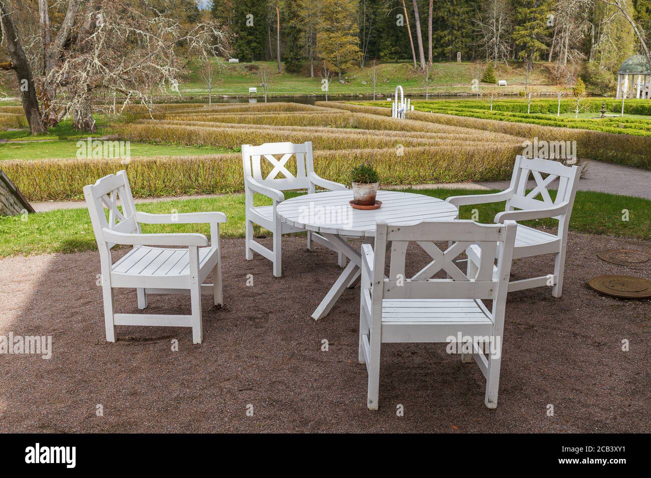 White wooden garden table and chairs with park at the background Stock
