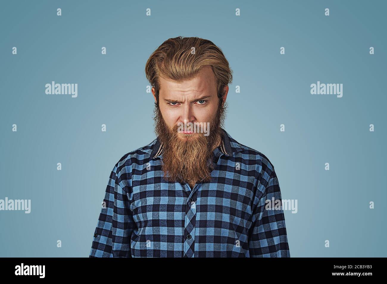 Closeup portrait of angry, annoyed, grumpy, mad man. Bad attitude, personality, interpersonal conflict resolution, intelligence. Hipster male with bea Stock Photo
