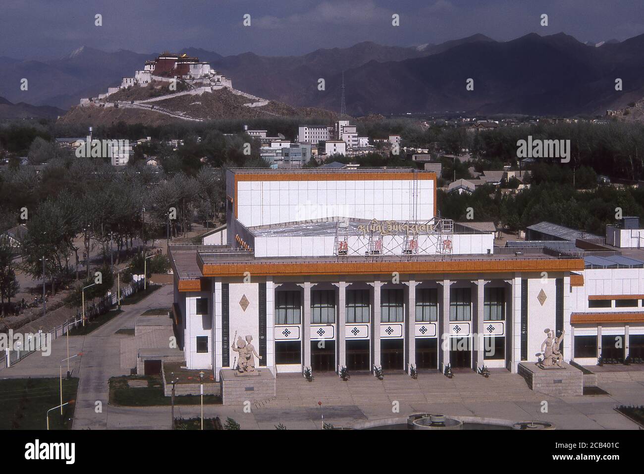TIBET - THEATRE IN LHASA WITH POTALA PALACE IN BACKGROUND. Stock Photo