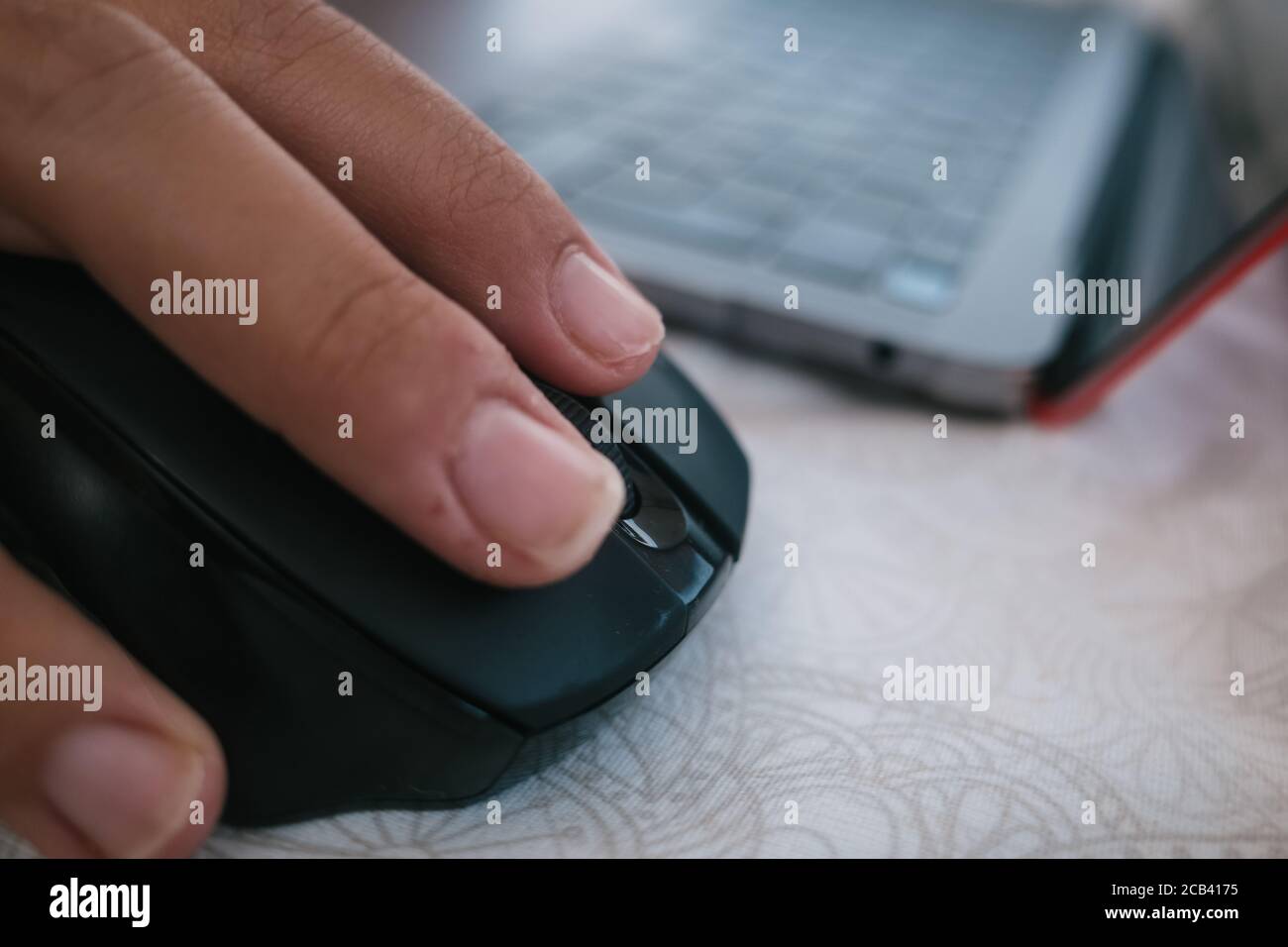 Selective focus shot of a male hand using a wireless computer mouse Stock Photo