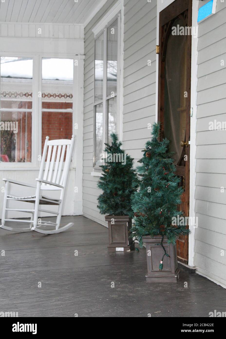 Rocking chair and  decorative trees on balcony Stock Photo