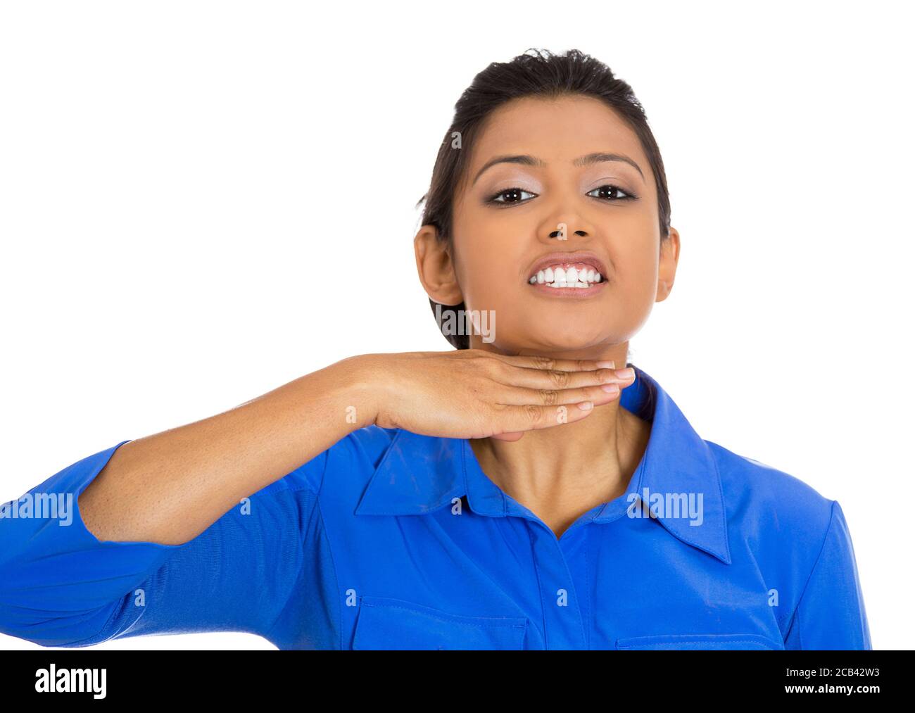 Closeup portrait of angry young woman gesturing with hand to stop talking, cut it out, or that she will take your head off, isolated on white backgrou Stock Photo