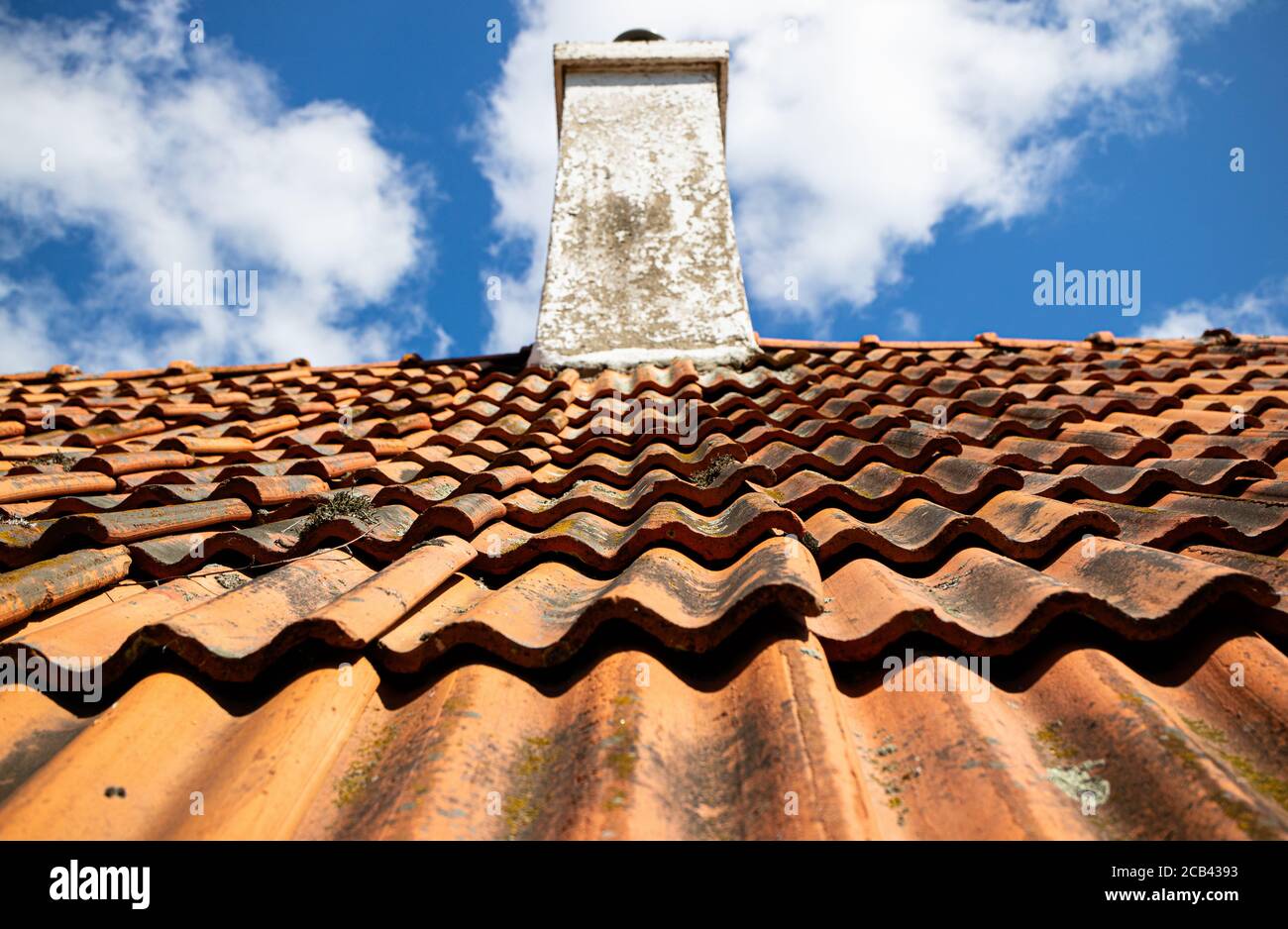 Low angle shot of a brick roof with a cloudy sky background Stock Photo ...