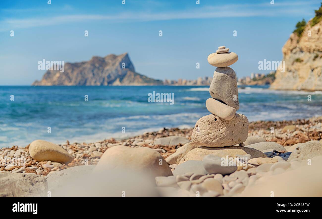 Art of stone balance, piles of stones on the Cala Baladrar beach. Costa Blanca. Spain Stock Photo