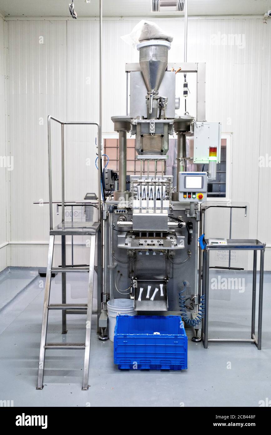 A packaging machine for single servings of organic agave syrup at the