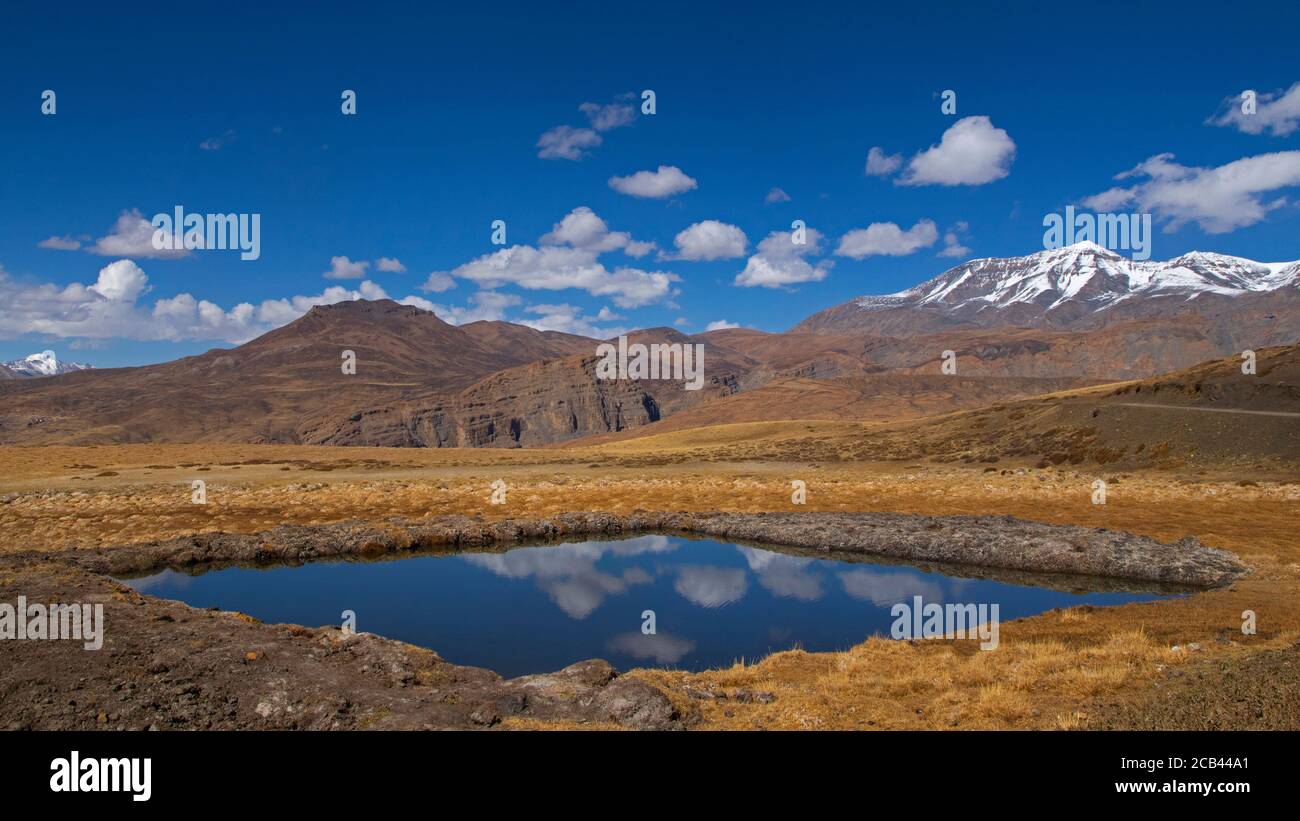 Water reserve on a dry land in Spiti Valley for irrigation purpose, clocked on a partly cloudy morning. Stock Photo