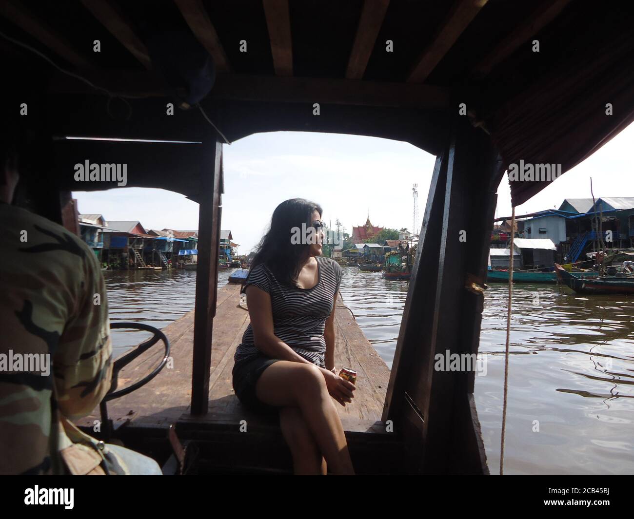 an woman enjoying boat journey on tonle sap lake of Cambodia Stock Photo