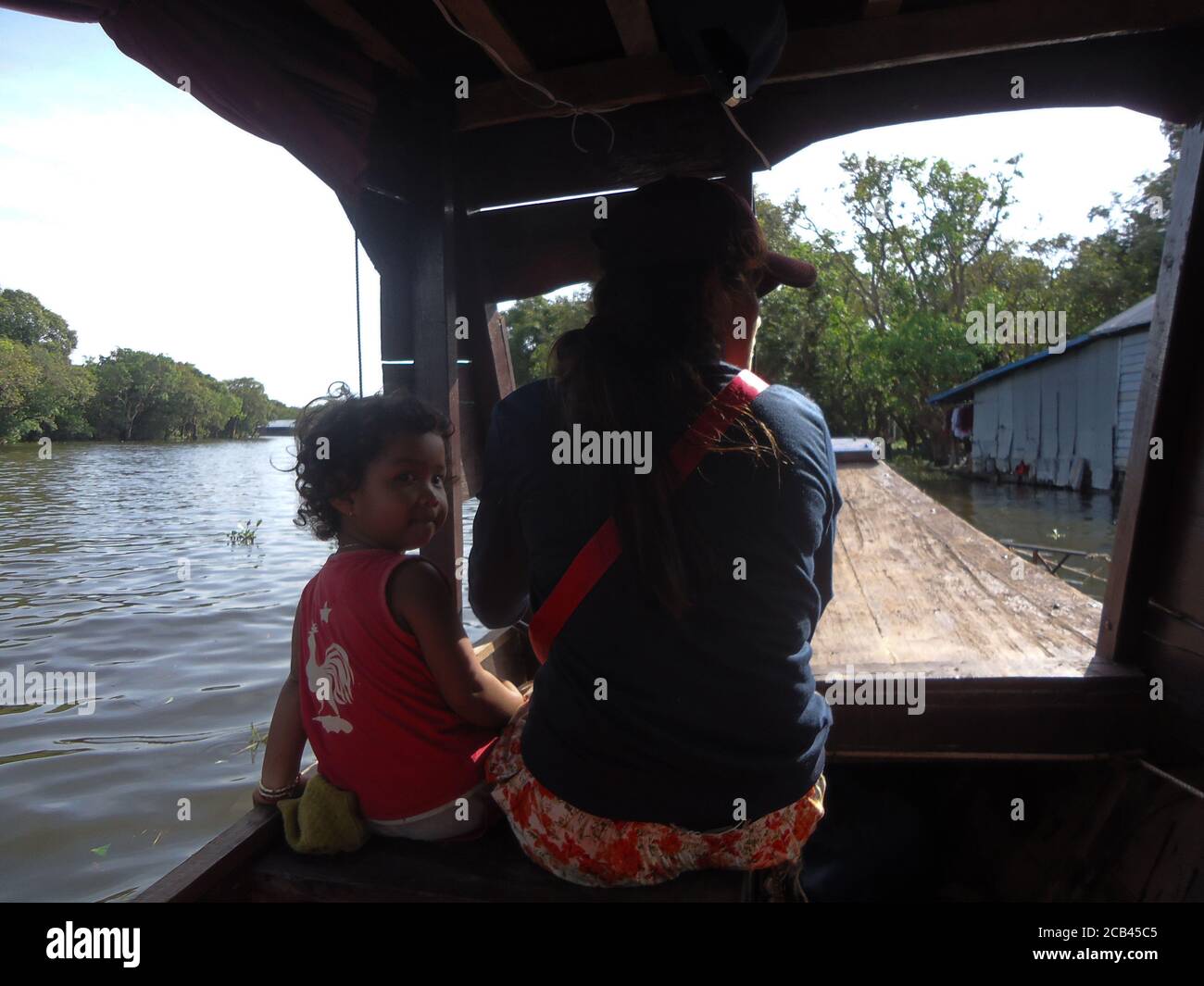 an woman and her daughter enjoying boat journey on tonle sap lake of Cambodia Stock Photo