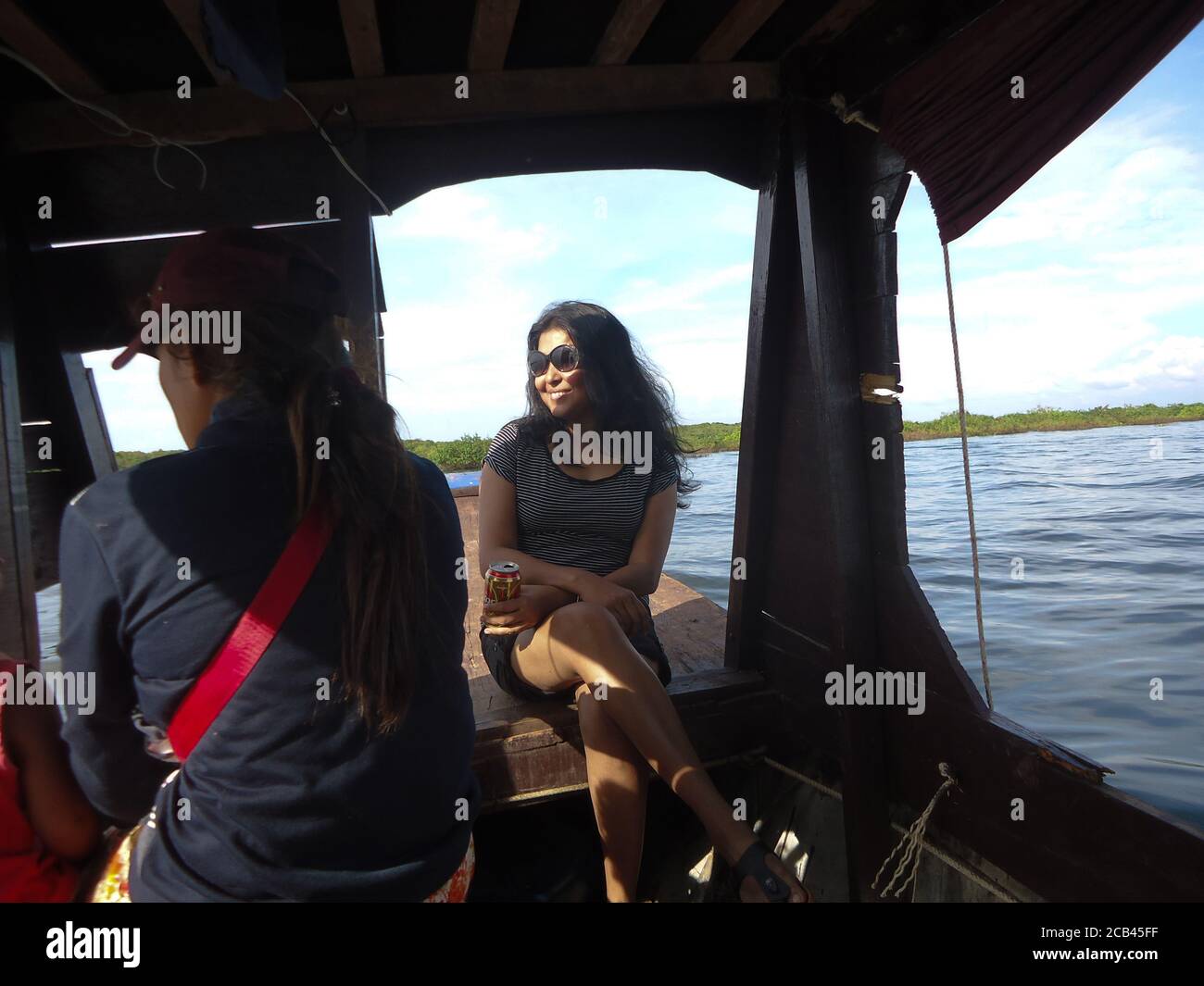 an woman enjoying boat journey on tonle sap lake of Cambodia Stock Photo