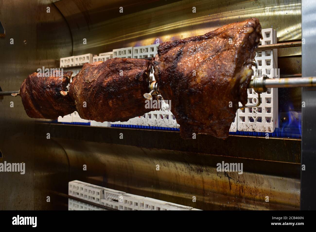 Three Well-Done Racks of Ribs Inside a Rotisserie Stock Photo - Alamy