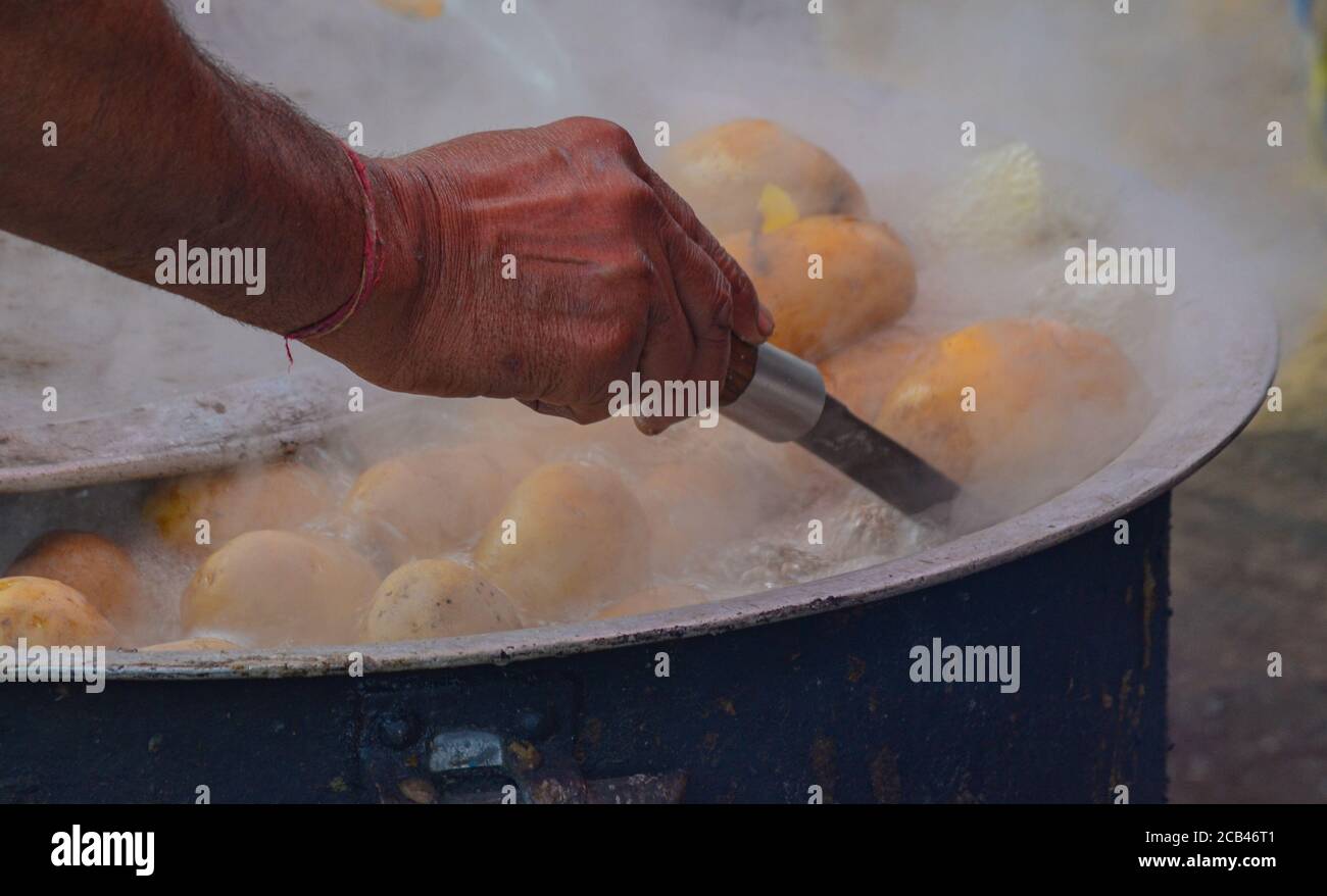 Boiling potatoes at a street kitchen providing food for the temple in Amritsar, India Stock Photo