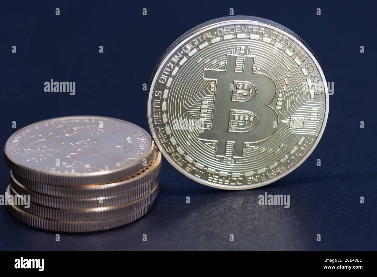 a gold Bitcoin coin is equivalent to a stack of gold dollars worth 10000  dollars Stock Photo - Alamy