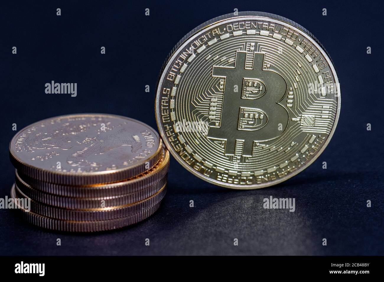 a gold Bitcoin coin is equivalent to a stack of gold dollars worth 10000  dollars Stock Photo - Alamy