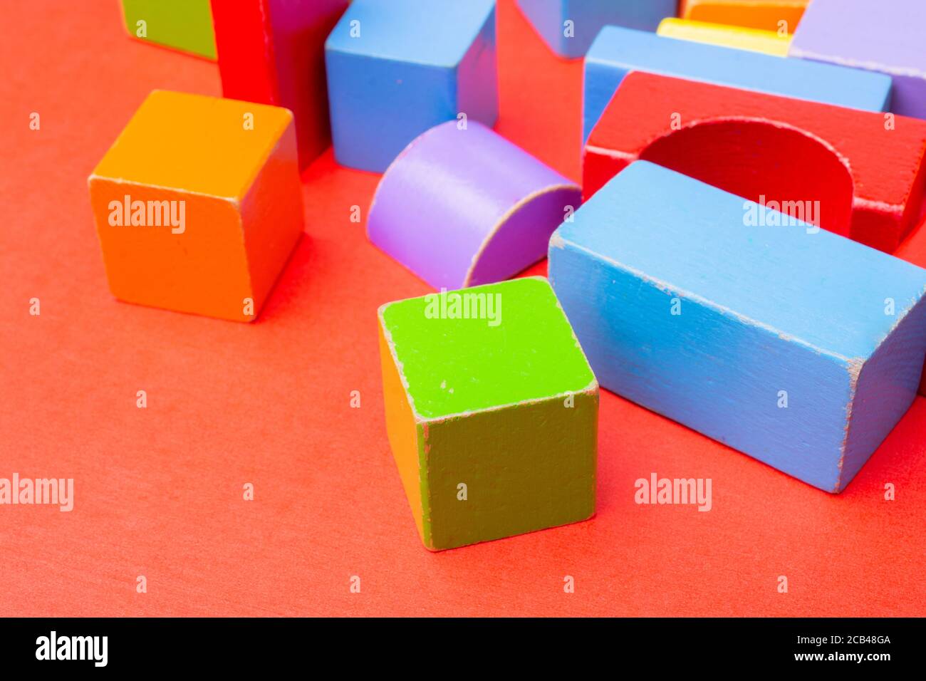 Different color and shape wooden toy building blocks Stock Photo Alamy
