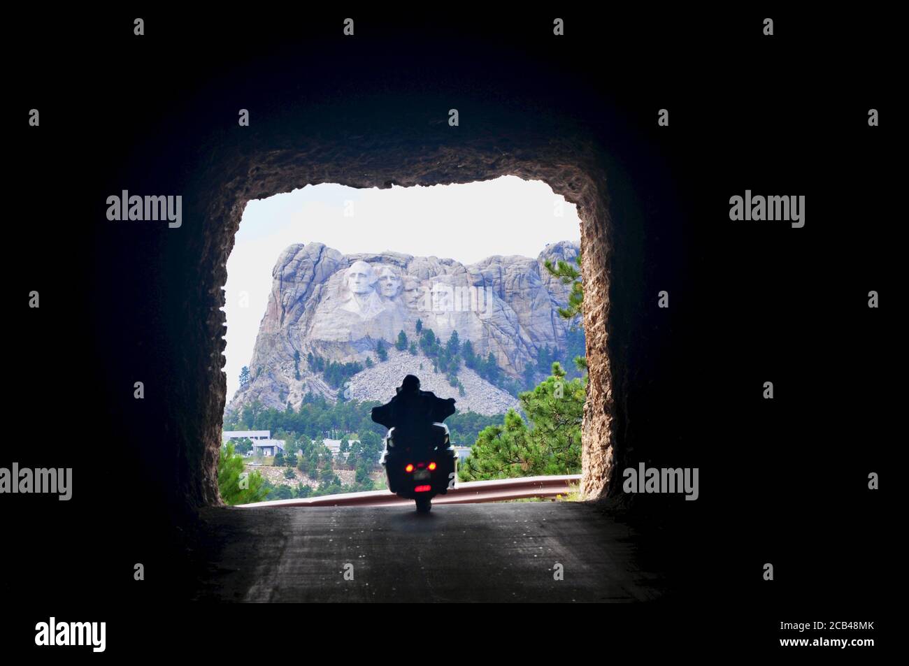 Motorcycle Driving through a Tunnel on the Needles Highway with a view