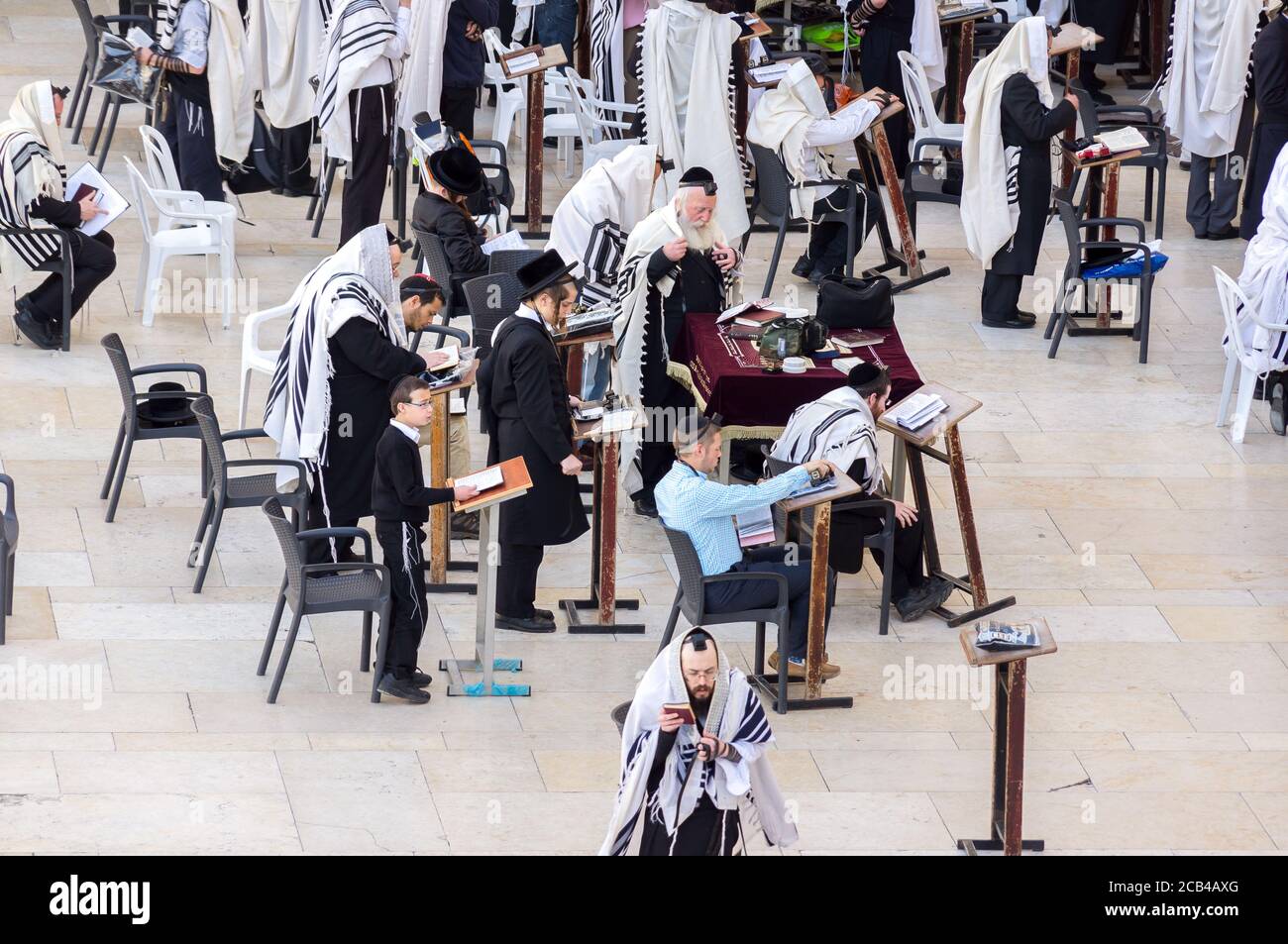 Jerusalem, Israel - 15.04.2015. Orthodox Jewish men pray at western wall in the morning Stock Photo