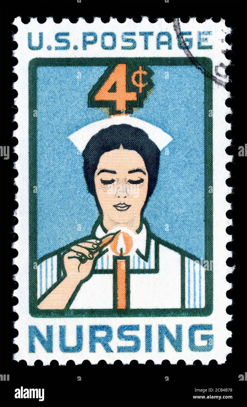 London, UK, February 19 2018 - Vintage 1961 USA 4c cancelled postage stamp showing an image of a Nurse lighting Candle of Dedication for nursing stamp Stock Photo