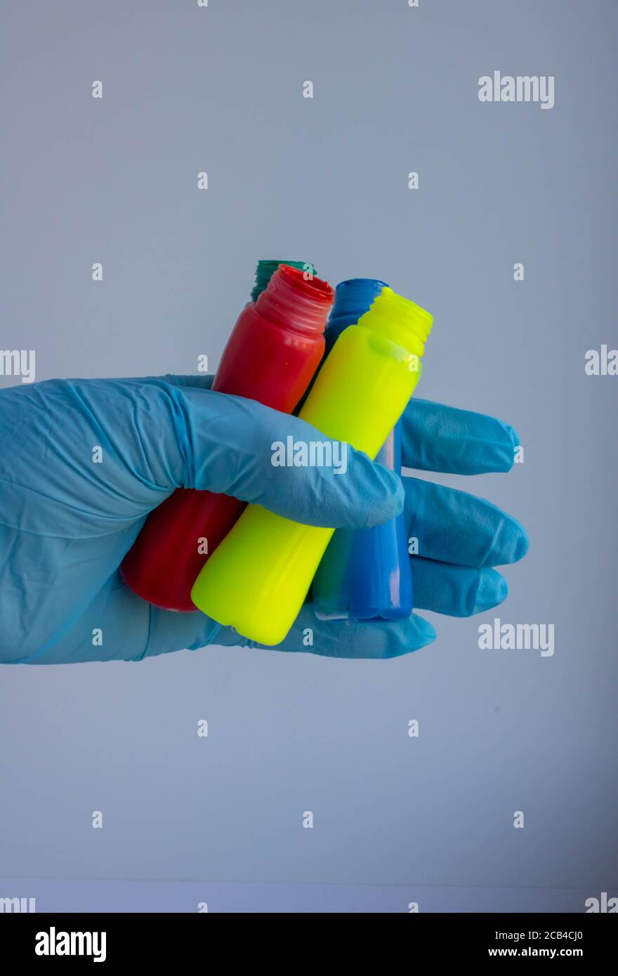 Painted latex gloves with paint on background Stock Photo Alamy
