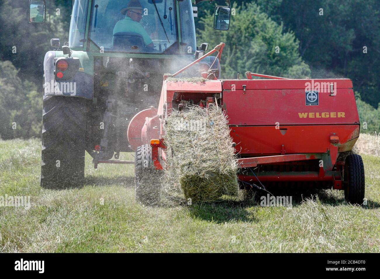Trossingen, Germany, June 25, 2020. 40 years old Welger baler in use on the hay field. Stock Photo