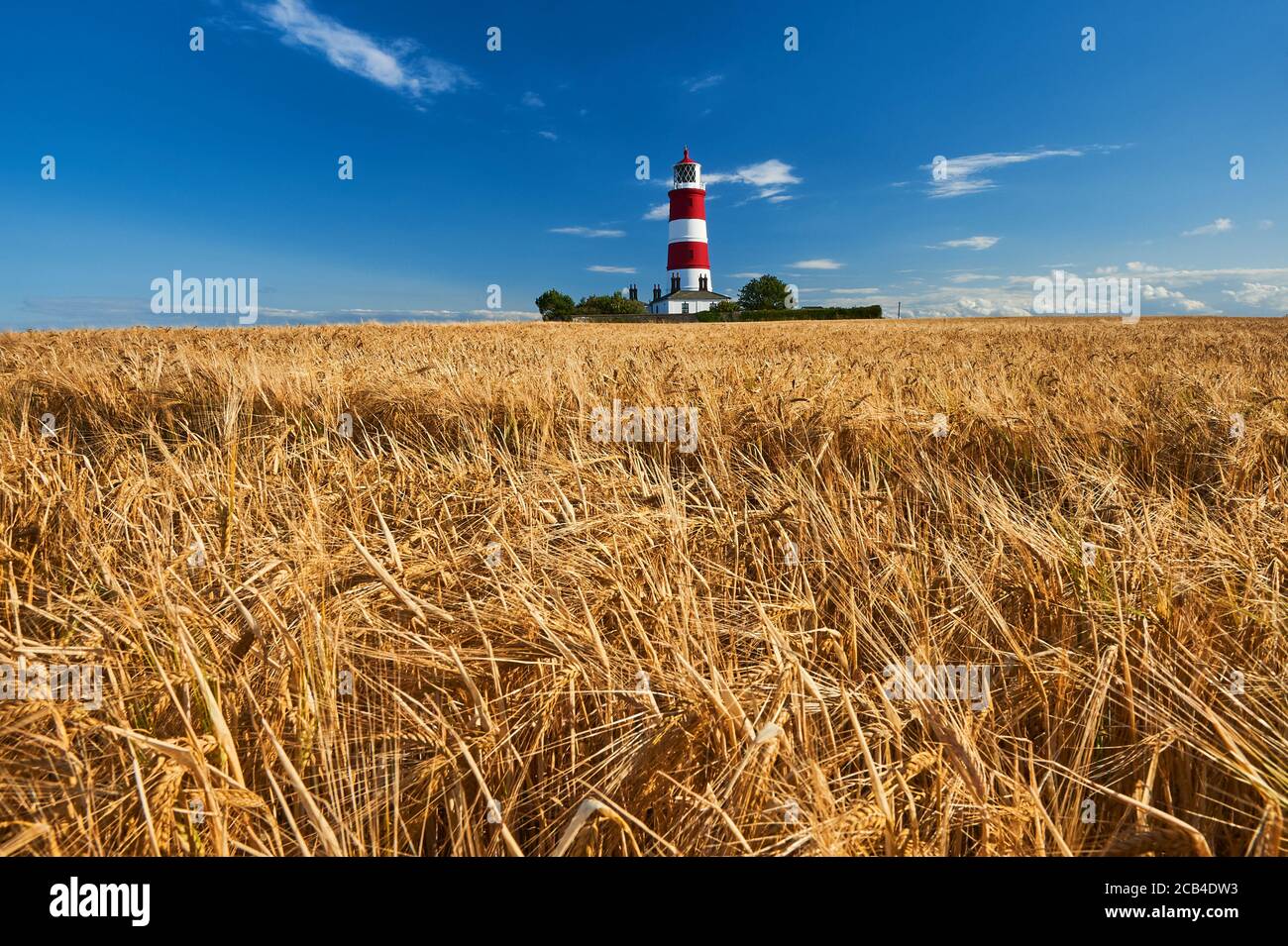 Happisburgh lighthouse Norfolk, iconic red and white striped building against a clear blue summer sky. Stock Photo