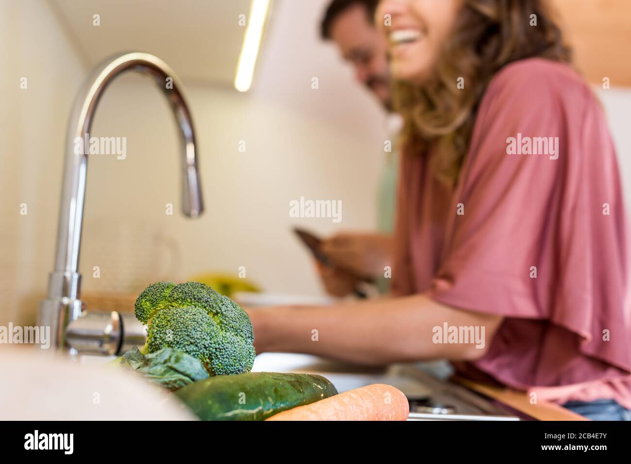 Young couple chilling out while preparing the lunch Stock Photo