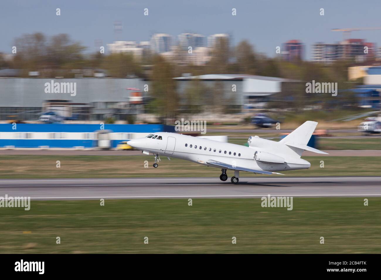 Side view of a luxury corporate or private jet taking off, in motion