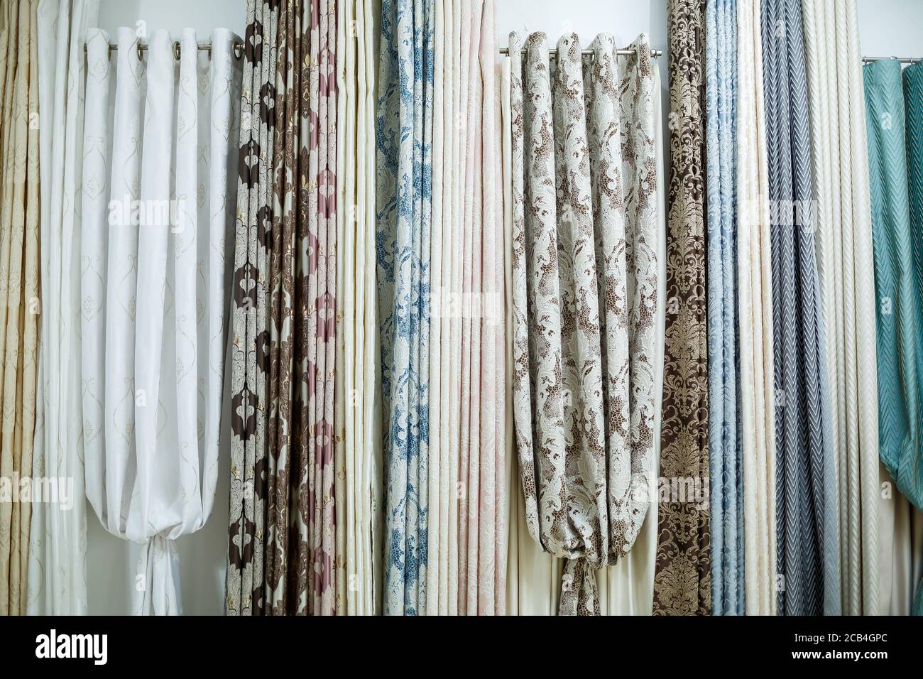 Curtain samples hanging from hangers on rail in store. Fabric texture  samples selection fabrics for interior decoration Curtains, tulle and  furniture Stock Photo - Alamy
