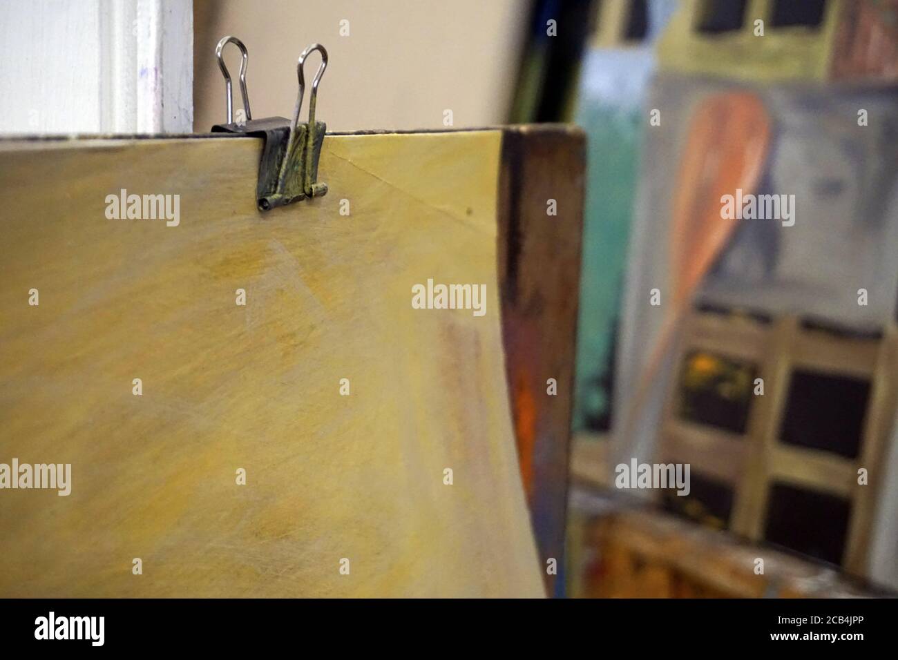 Paper binder clip on a painting Stock Photo Alamy