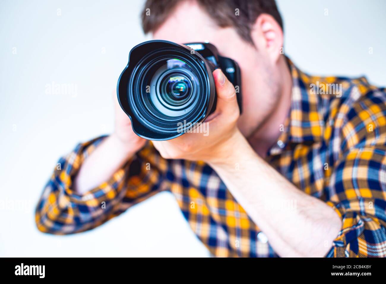 Closeup of a young man holding a camera Stock Photo