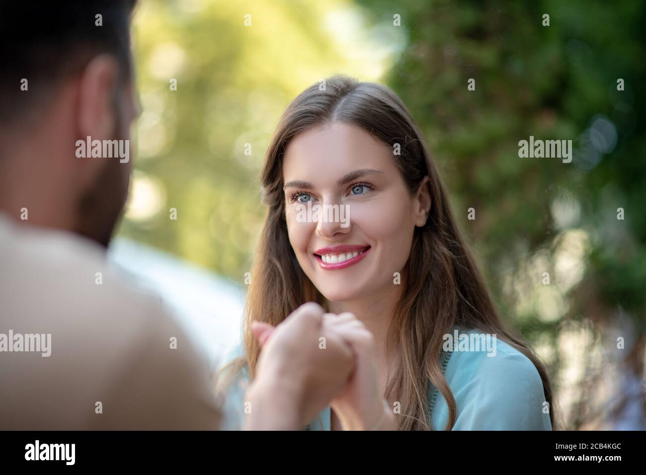 Couple looking at each other, holding hands Stock Photo - Alamy