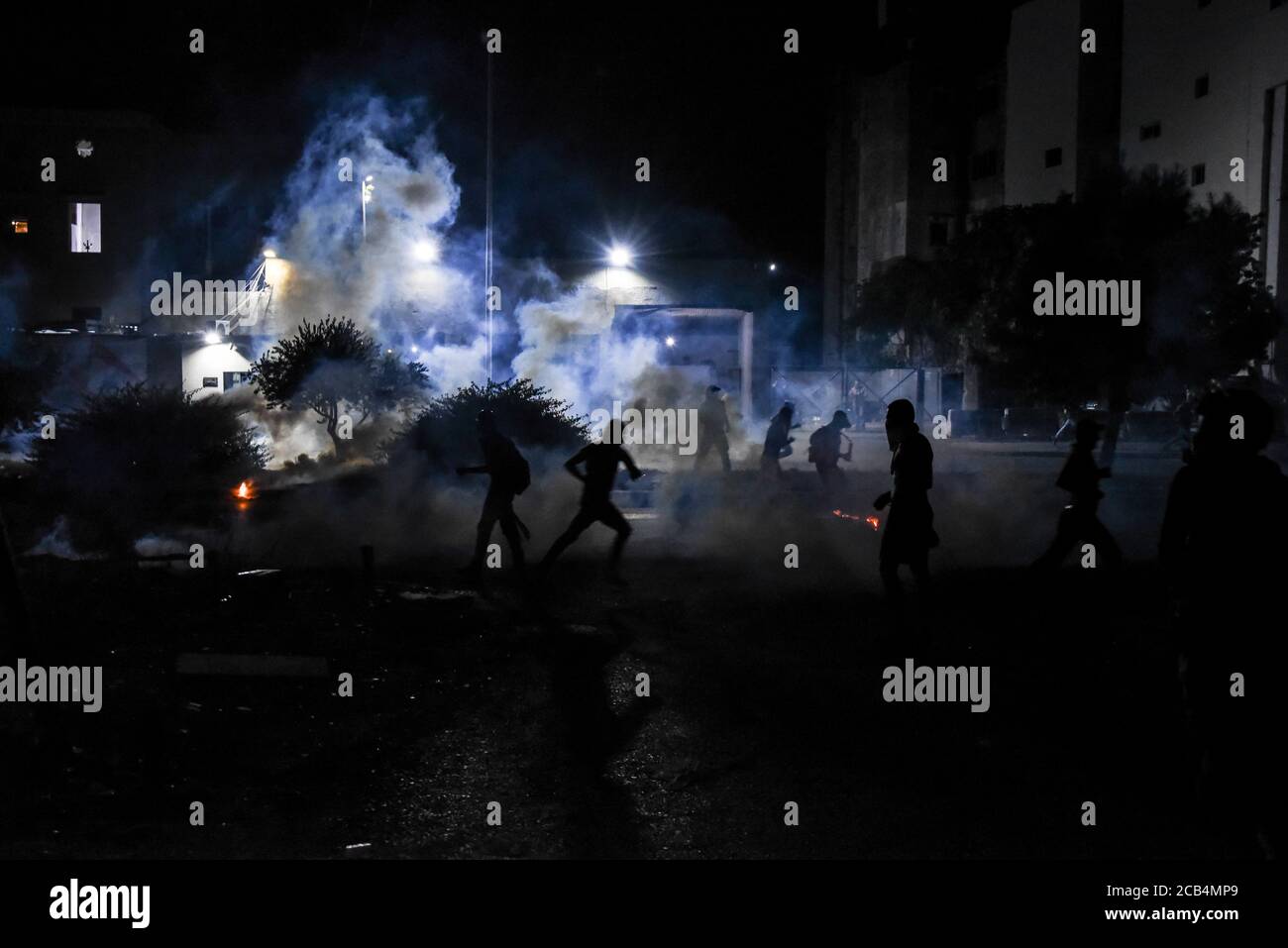 Downtown Beirut, Lebanon, 10 August 2020. Protesters pushed back by tear gas shot at them by Security Forces shortly after Prime Minister Hassan Diab announced the resignation of his entire cabinet due to endemic corruption culminating in a huge explosion at the Port of Beirut that killed 200, injured over 6000, decimated large areas of the capital and made over 300 thousand people homeless. Elizabeth Fitt Stock Photo