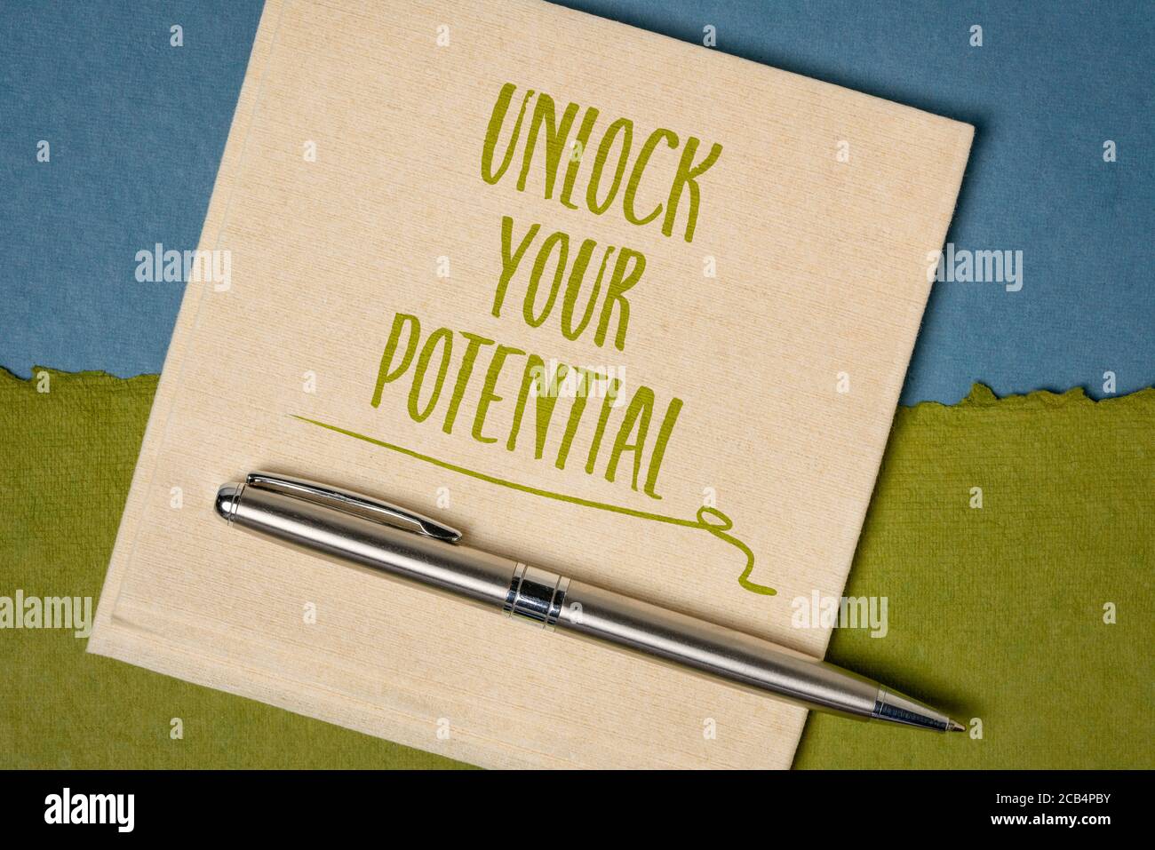 Unlock your potential inspirational reminder note - handwriting on a napkin, self improvement and personal development concept Stock Photo