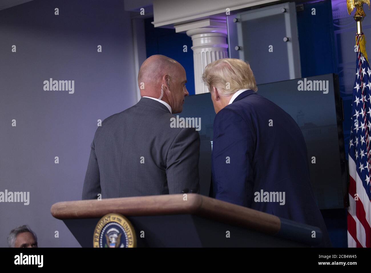 Washington, United States. 10th Aug, 2020. President Donald Trump is removed from the White House Briefing Room by a US Secret Service agent during a press conference in Washington, DC on Monday, August 10, 2020. Photo by Stefani Reynolds/UPI Credit: UPI/Alamy Live News Stock Photo