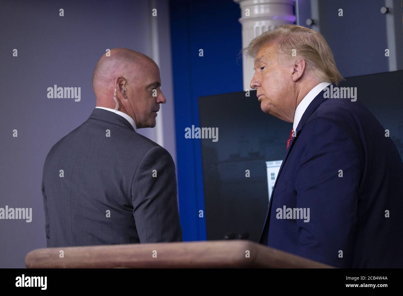 Washington, United States. 10th Aug, 2020. President Donald Trump is removed from the White House Briefing Room by a US Secret Service agent during a press conference in Washington, DC on Monday, August 10, 2020. Photo by Stefani Reynolds/UPI Credit: UPI/Alamy Live News Stock Photo