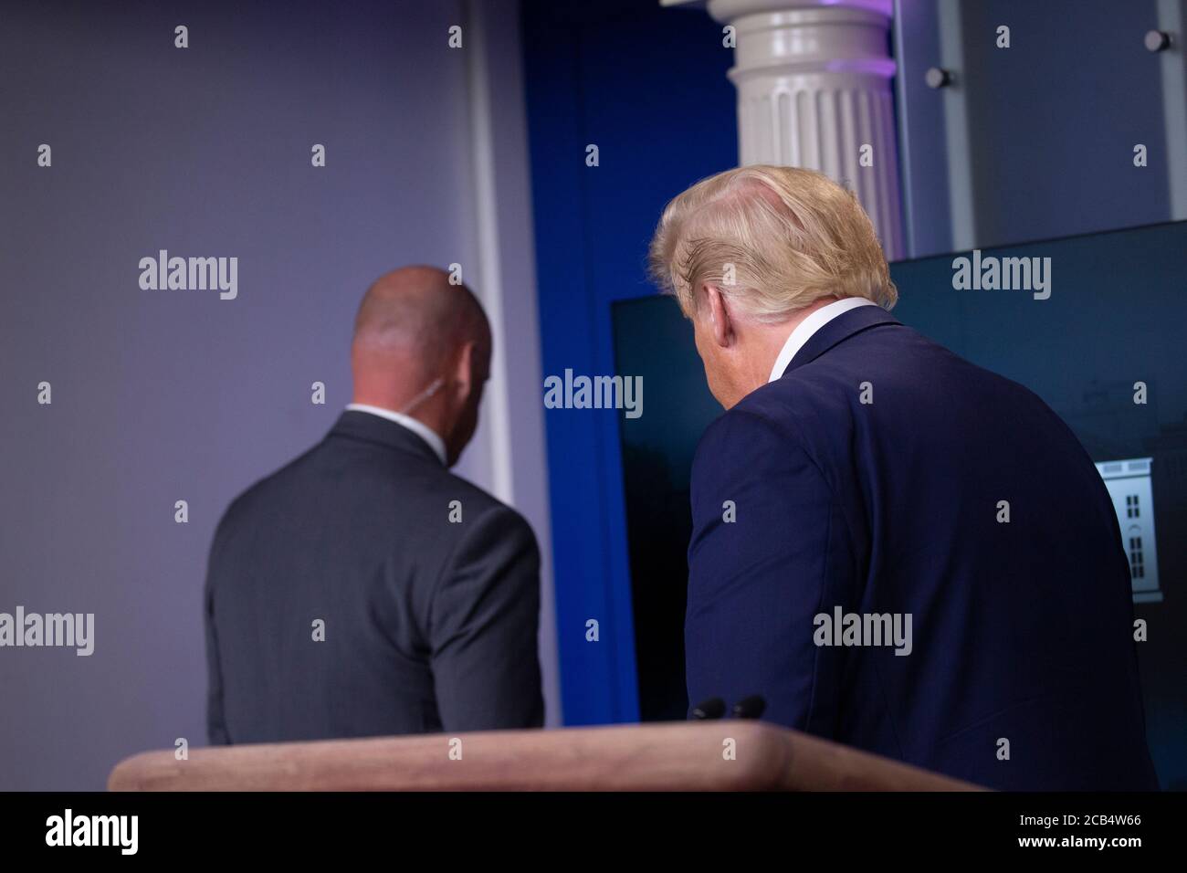 United States President Donald J. Trump is removed from the White House Briefing Room by a US Secret Service agent during a press conference in Washington, DC on Monday, August 10, 2020.Credit: Stefani Reynolds/Pool via CNP /MediaPunch Stock Photo