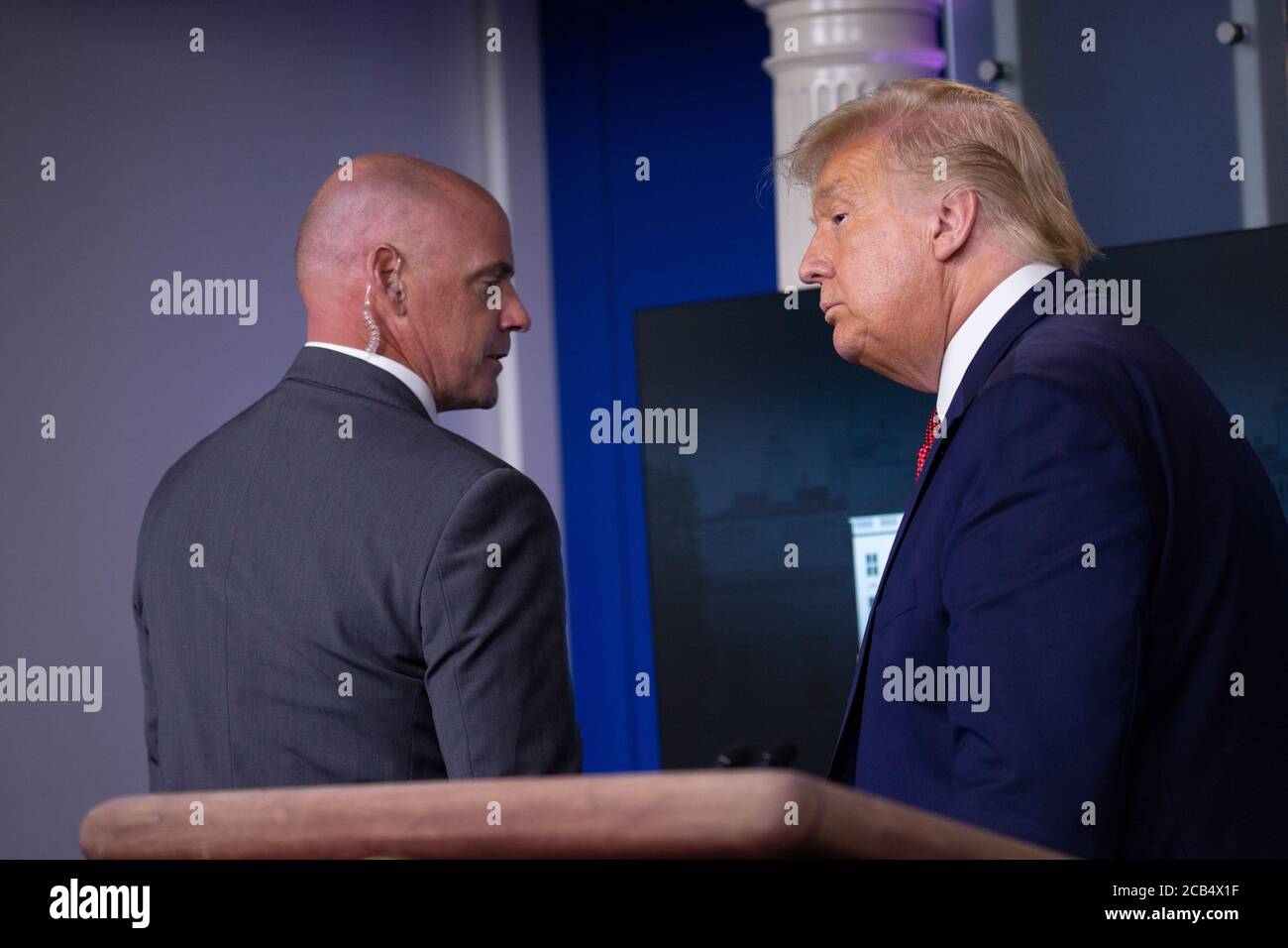 Washington, United States Of America. 10th Aug, 2020. United States President Donald J. Trump is removed from the White House Briefing Room by a US Secret Service agent during a press conference in Washington, DC on Monday, August 10, 2020.Credit: Stefani Reynolds/Pool via CNP | usage worldwide Credit: dpa/Alamy Live News Stock Photo