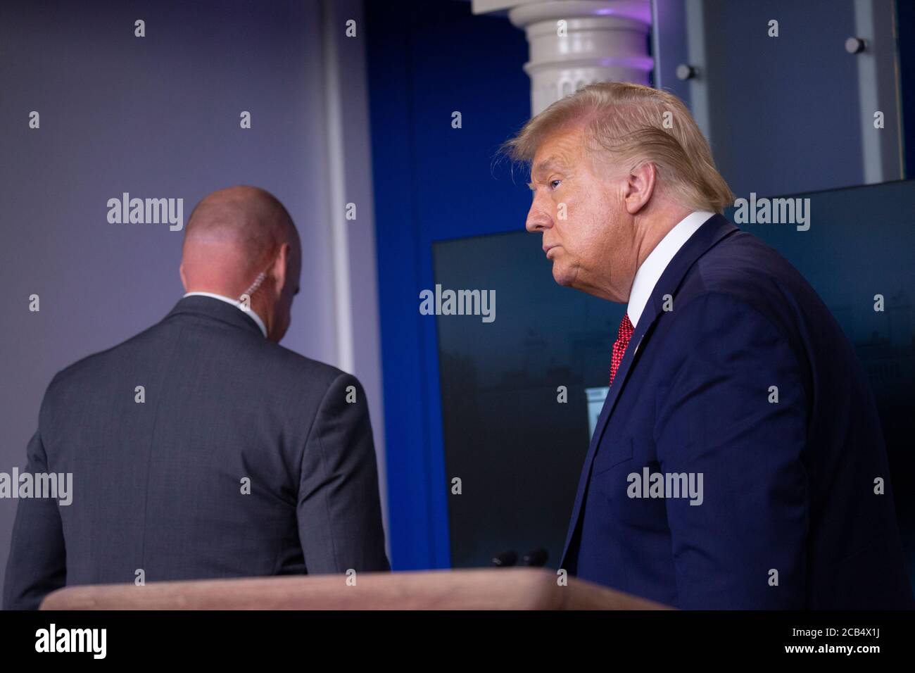 Washington, United States Of America. 10th Aug, 2020. United States President Donald J. Trump is removed from the White House Briefing Room by a US Secret Service agent during a press conference in Washington, DC on Monday, August 10, 2020.Credit: Stefani Reynolds/Pool via CNP | usage worldwide Credit: dpa/Alamy Live News Stock Photo